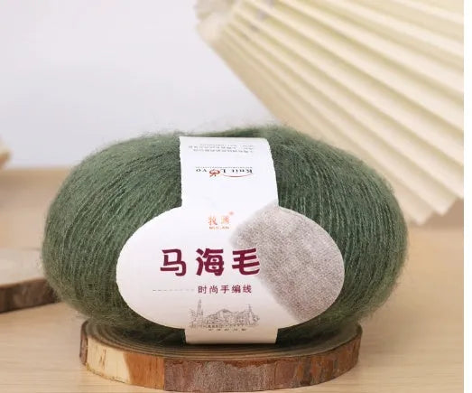 Ball of mohair yarn for DIY scarf knitting in one of 34 colours, including white, pink, blue, and green.