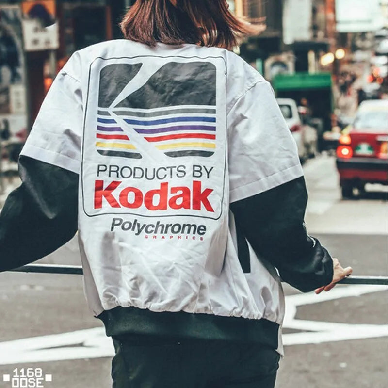 Hip hop style printed baseball jacket in Grey with round neck and side slit pockets on a model