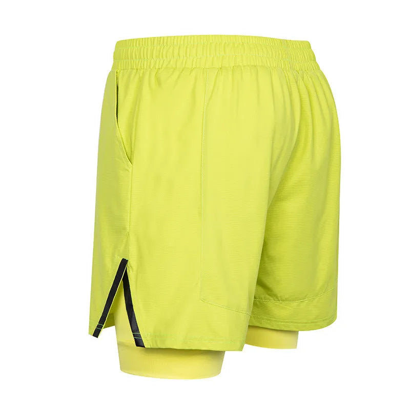 Man wearing quick-drying plaid sports shorts in army green, showing mid waist and shorts length.