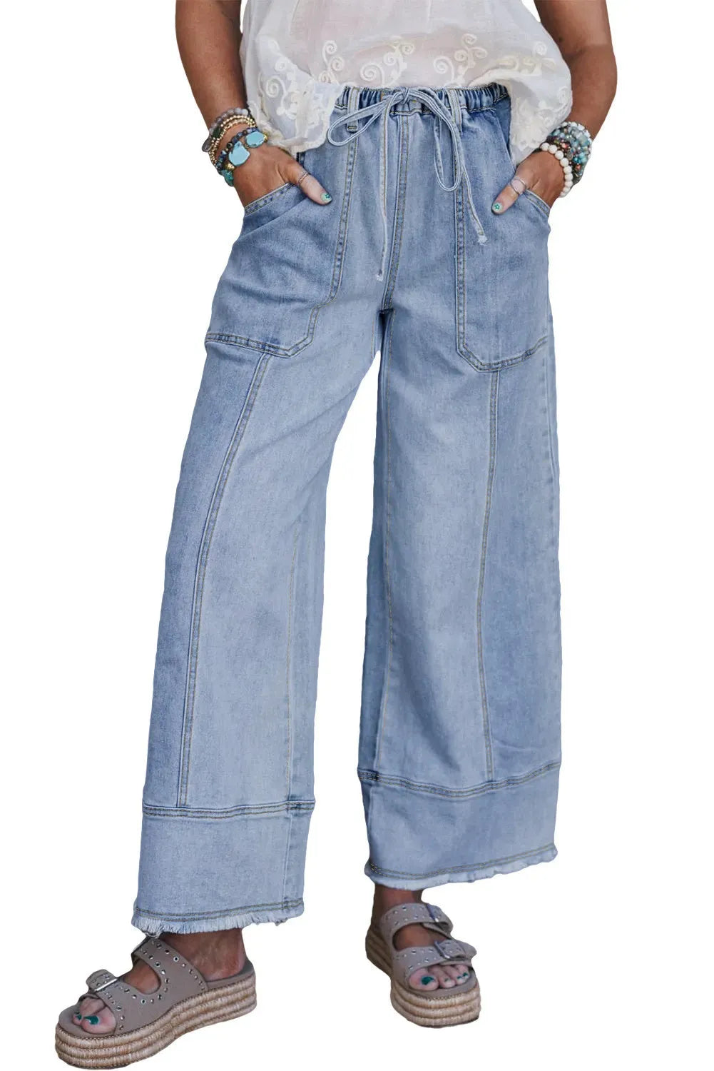 Beau blue women's wide-leg denim trousers with a drawstring waistband and raw hem detail.
