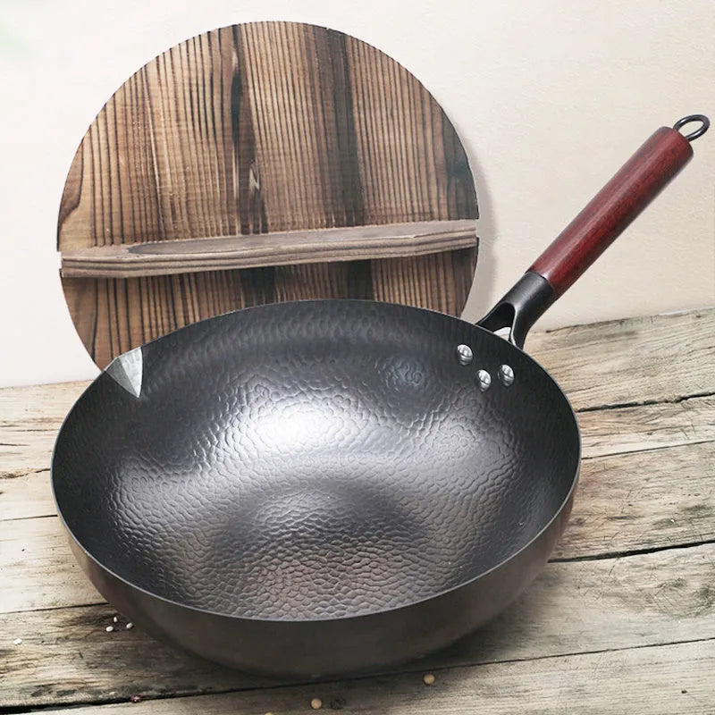 Traditional black cast iron wok with a long wooden handle, shown with a glass lid.