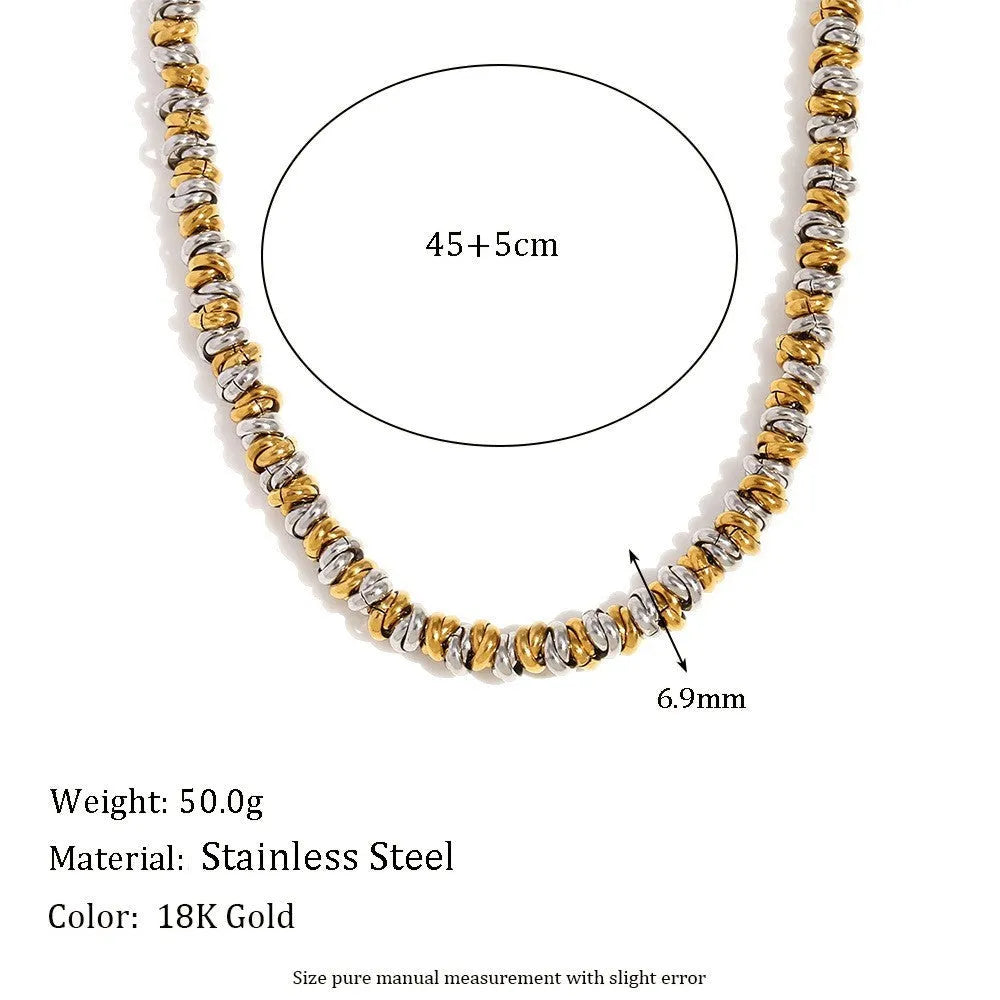 Gold geometric stainless steel jewellery set for women, showing earrings, necklace, and bracelet with electroplated finish.