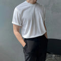 Men's slim fit cotton t-shirt in black on a hanger, showing round neck and half sleeve design.
