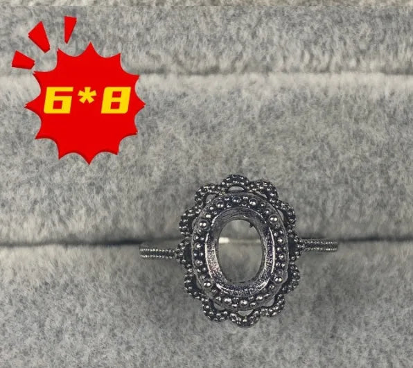 Oval denier fashion ring with open mouth setting, five-pointed star, and 6x8mm stone on copper band.