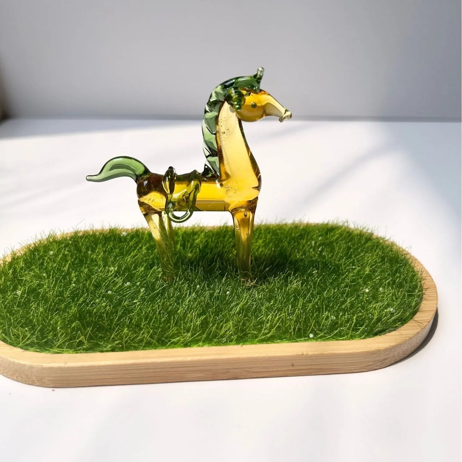 A smooth glazed horse figurine ornament in a modern minimalist style on a table.