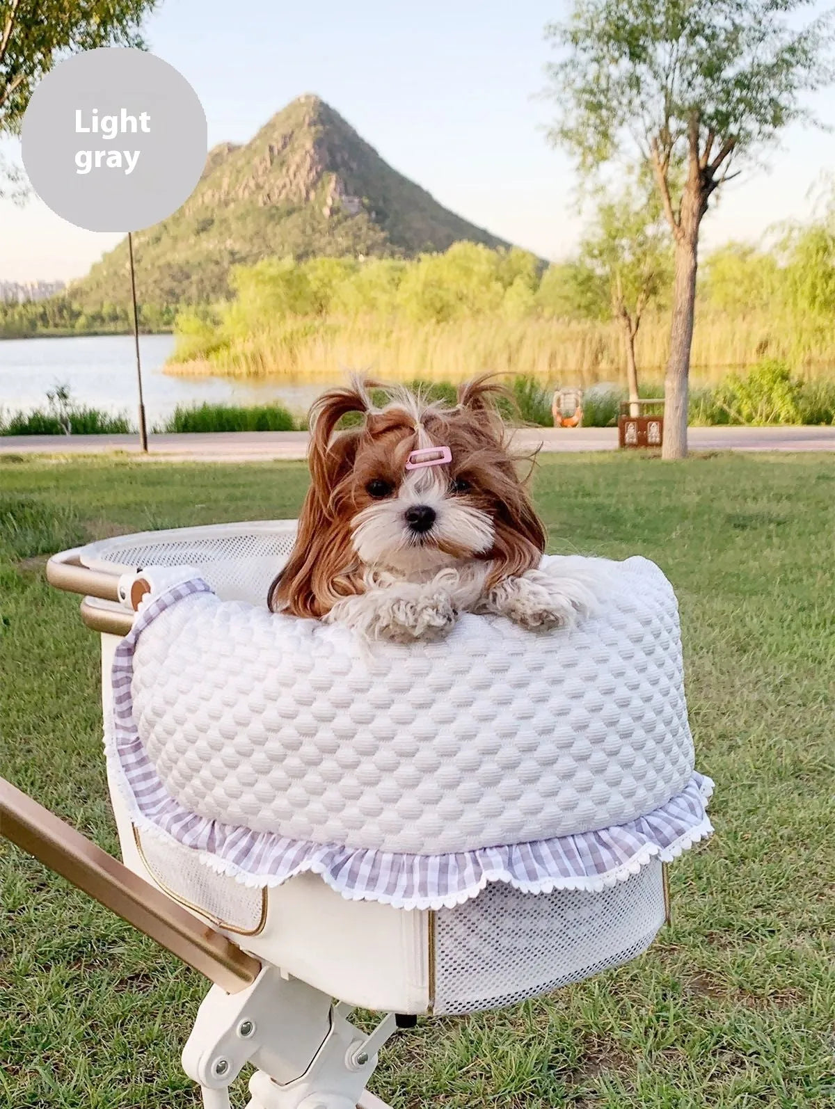 A green grey striped towel, cushion, and pillow set for a pet stroller, shown removed and ready for washing.