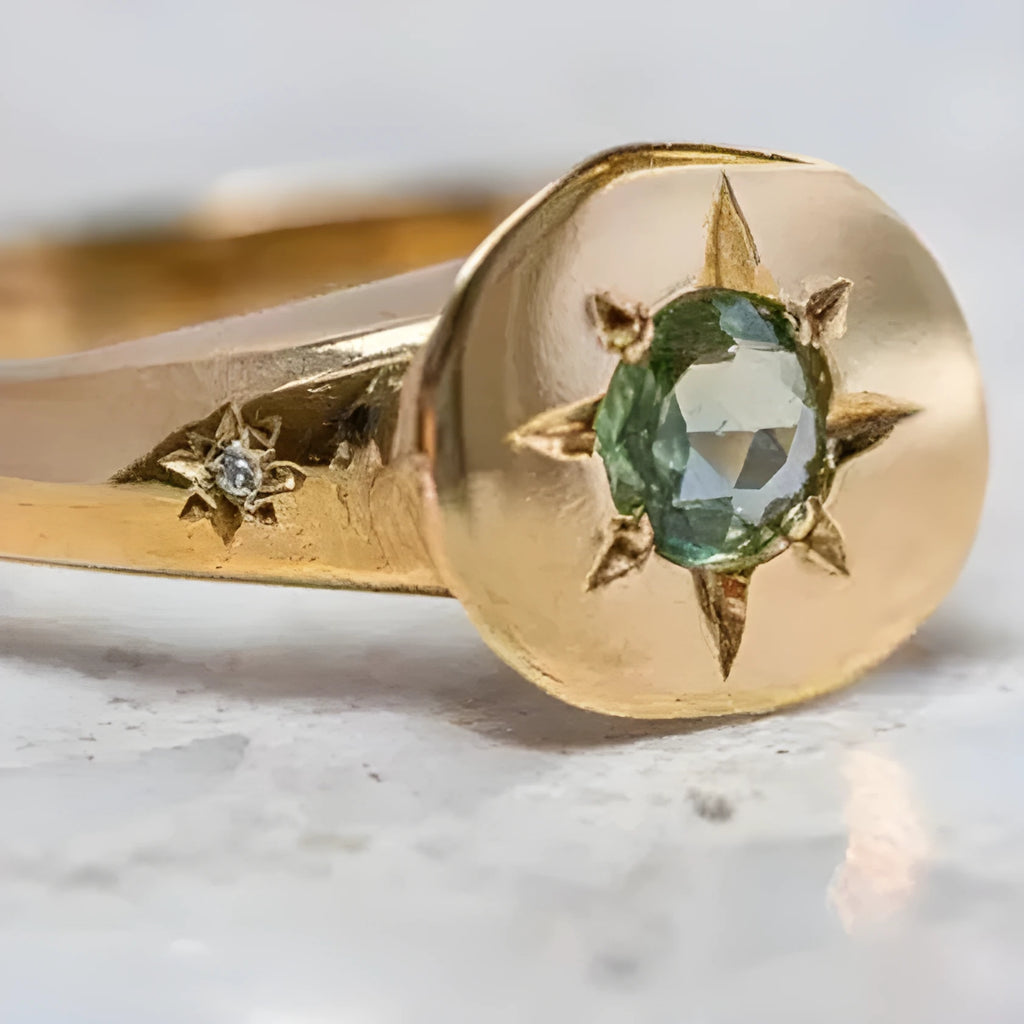 Gold-colour adjustable ring with oval band and central star-shaped zircon stone in a six-prong setting.