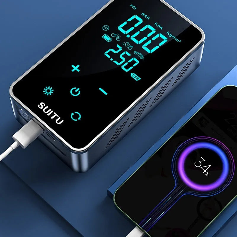 Compact black wireless car tyre pump with LCD screen on a cloth bag alongside its charging cable and nozzles.