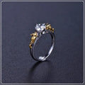 Close-up of a black gold finished copper ring with a detailed 1.5cm tall crown model on a person's finger.