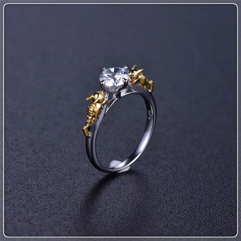 Close-up of a black gold finished copper ring with a detailed 1.5cm tall crown model on a person's finger.