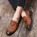 Men's black pointed toe slip-on shoe with a tassel on the low-top PU upper.