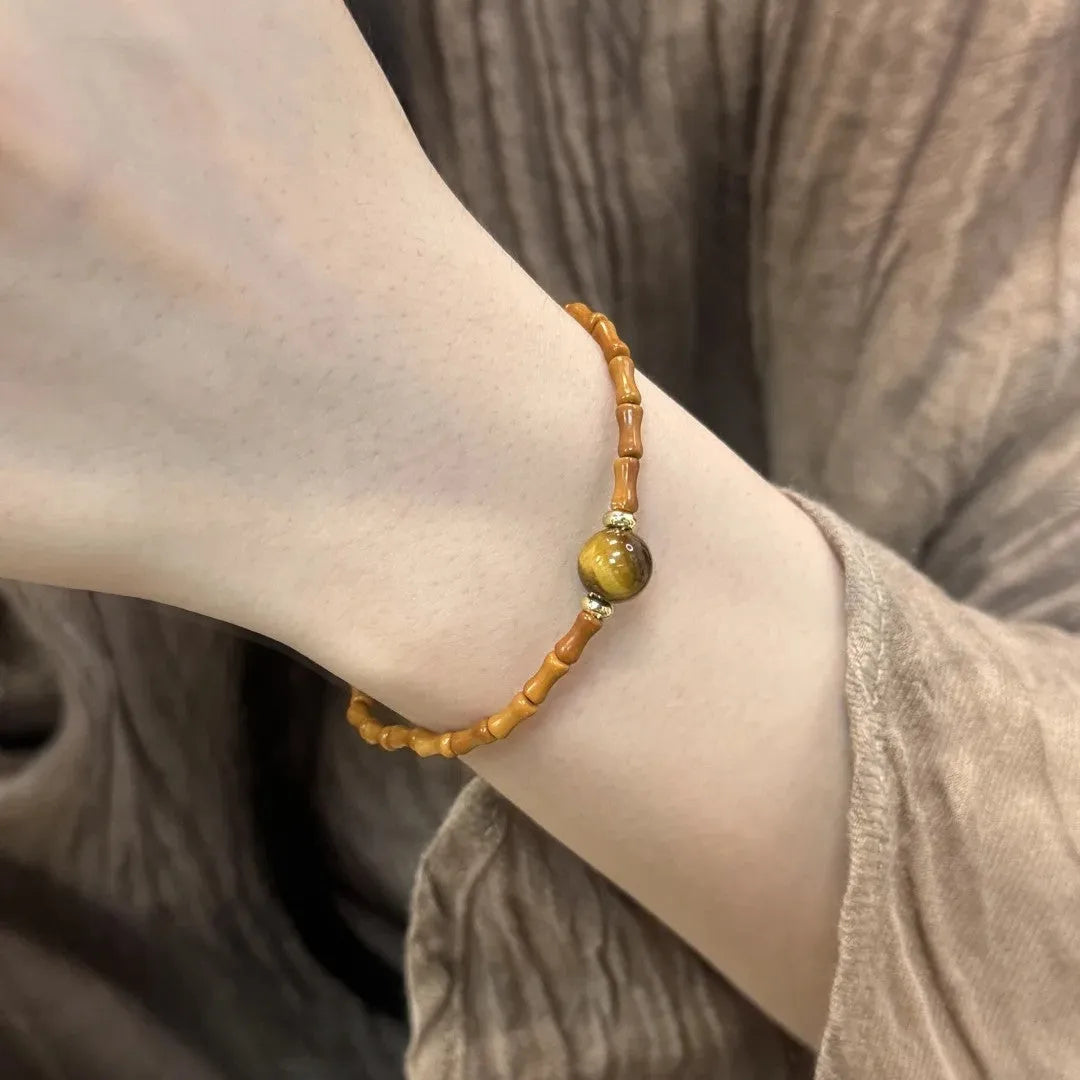 Natural yellow tiger's eye stone bracelet showing golden gourd, bamboo joint, and lace pattern variations
