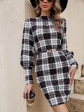 Black women's tight dress with lantern sleeves and leather stitching detail.