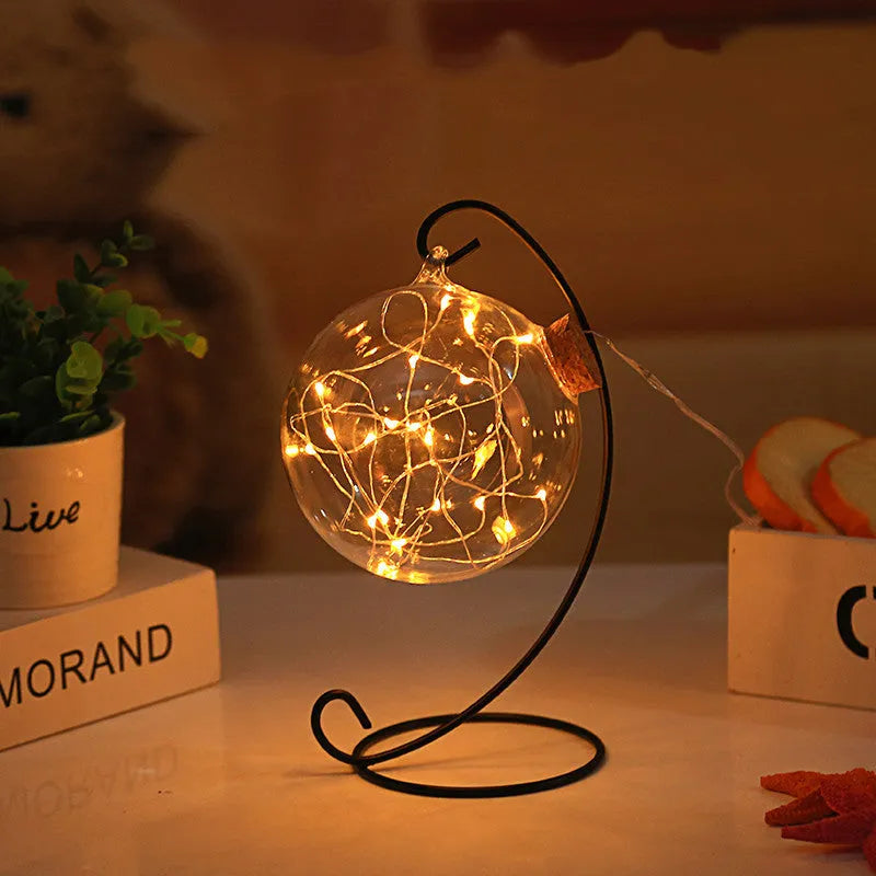 Round glass wish bottle with cork, 12 cm diameter, containing a warm white LED light strand with 20 lamp beads and folded paper stars
