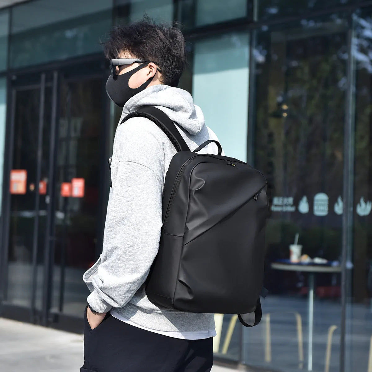 Large black waterproof backpack made from PU leather with sewing thread detailing