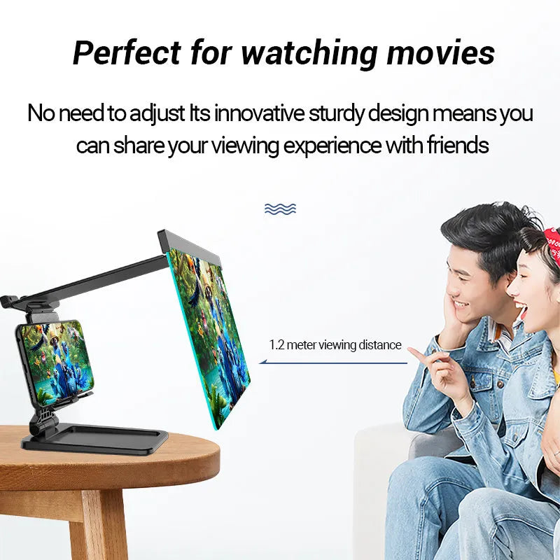 Black folding mobile phone screen magnifier and detachable phone holder on a desk.