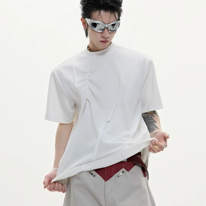 Men's grey pleated cotton t-shirt with round neck and short sleeves on a loose fit model