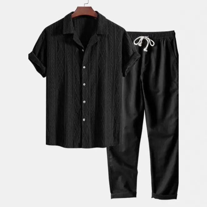 Lightweight linen-feel casual suit set with camouflage print trousers and a short-sleeved lapel shirt.