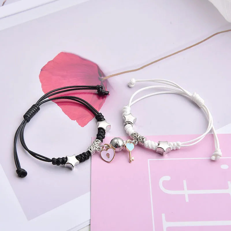Magnet suction couple bracelets with alloy construction and various pendant designs including crowns and hearts