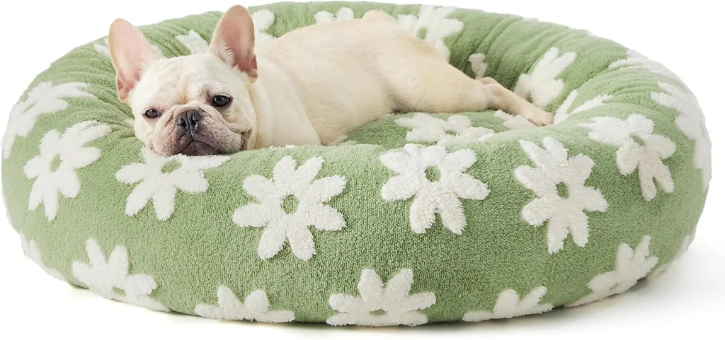 Round blue and white plaid dog bed with a plastic base on a wooden floor.