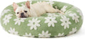 Round blue and white plaid dog bed with a plastic base on a wooden floor.