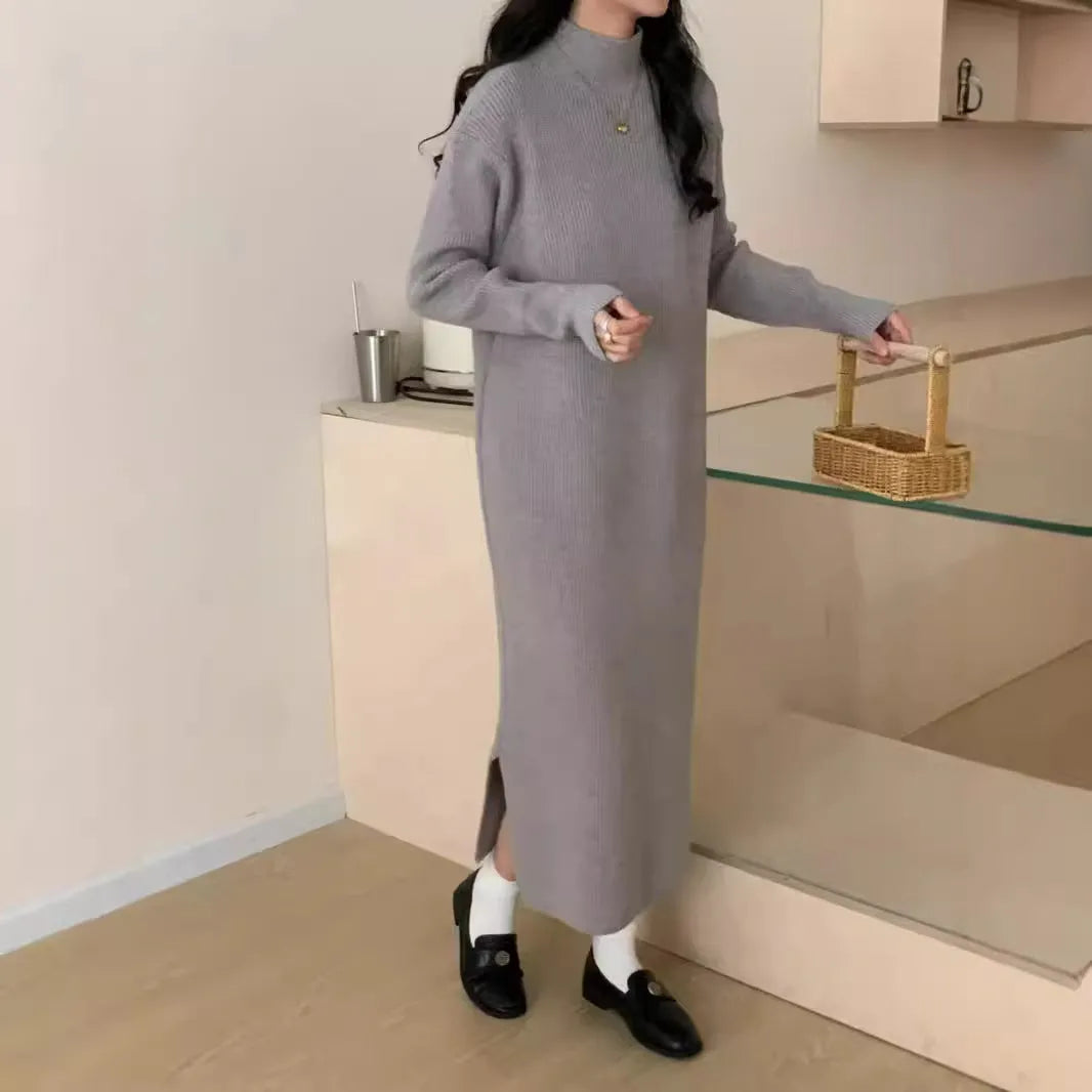 Woman wearing a milky white half turtleneck long sleeve knitted midi dress with a high waist.