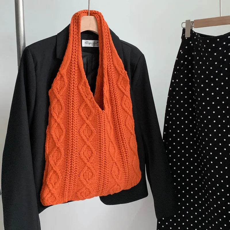 GWomen retro crochet shoulder tote bag in a solid colour, showing knitted texture and double strap connectors.