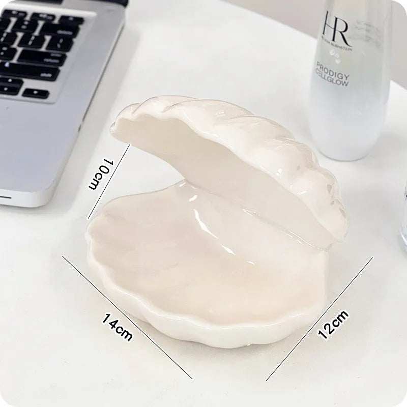 White porcelain storage tray with optional small night light, shown in pink and white shell colours on a wooden surface.