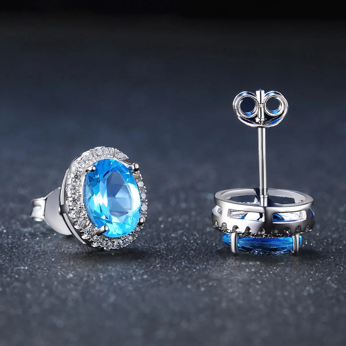 925 sterling silver blue topaz geometric jewellery set showing necklace, earrings, ring, and pendant