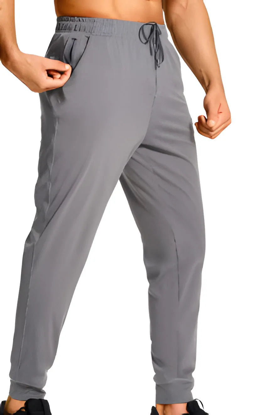 Men's loose fit casual trousers in solid colour polyester fabric showing relaxed cut and casual styling