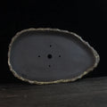Handmade purple clay flower pot showing natural ceramic texture and floor-standing design