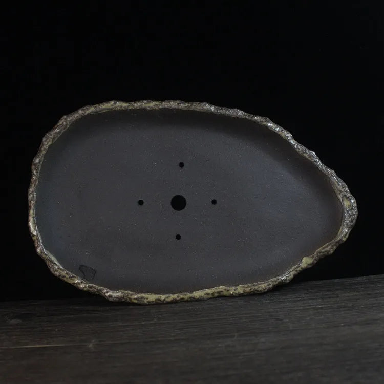Handmade purple clay flower pot showing natural ceramic texture and floor-standing design