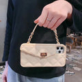 Beige silicone iPhone case with a white pearl chain lanyard attached, shown from the back.