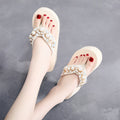 Women's beige high-heeled flip-flops with cotton cloth upper, shown from the side.