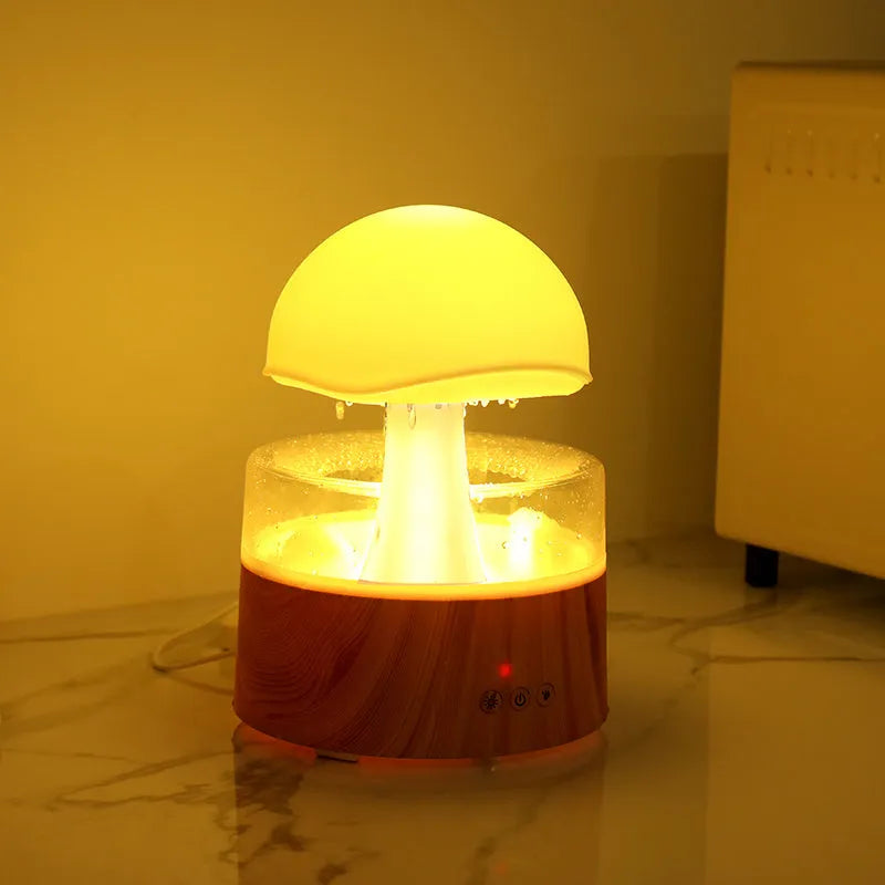 White cloud-shaped ultrasonic aroma diffuser and humidifier with simulated raindrops and coloured lights.