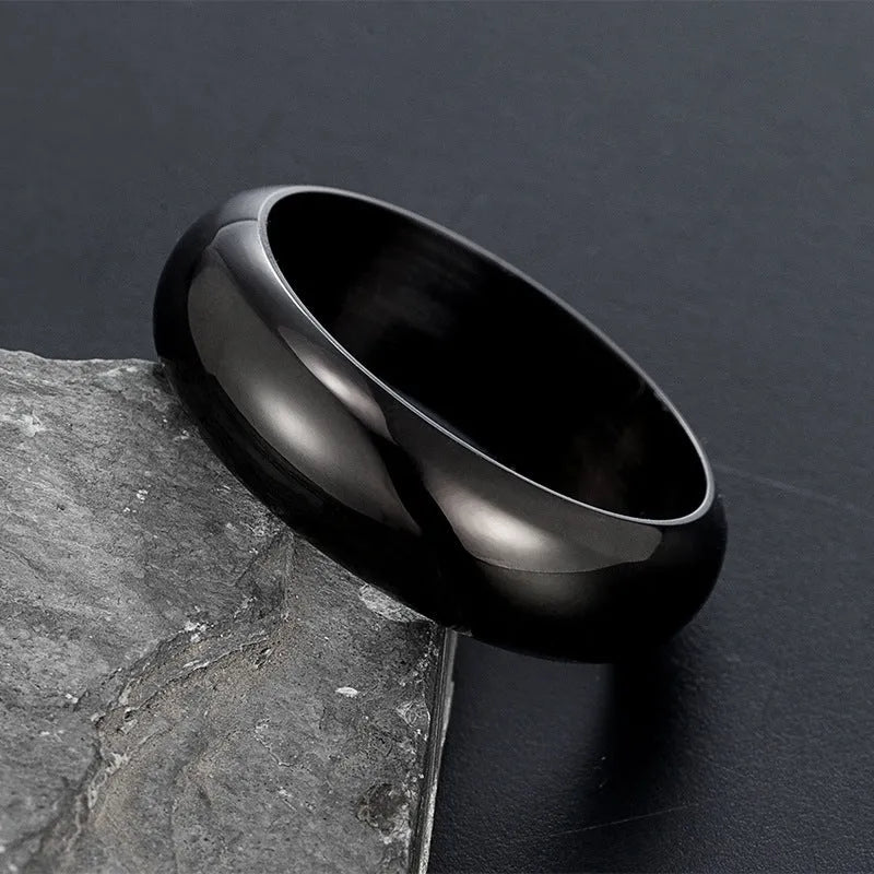 Glossy electroplated titanium steel ring in gold, black and steel colours showing metallic finish