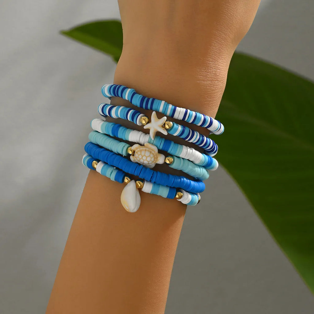 Set of six handmade bohemian polymer clay bracelets with shell and geometric designs in S3162 colour.