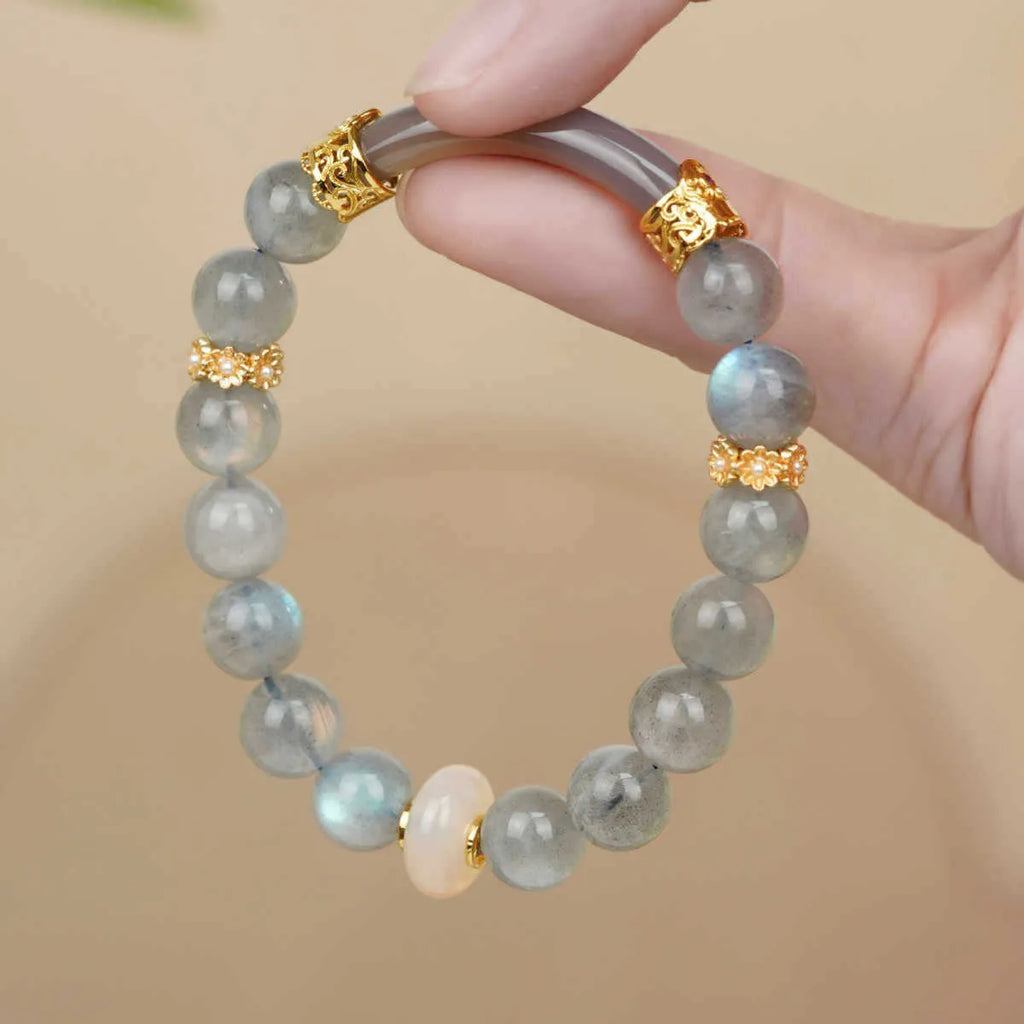 Grey moonstone women's bracelet with 8mm round beads on a wrist.