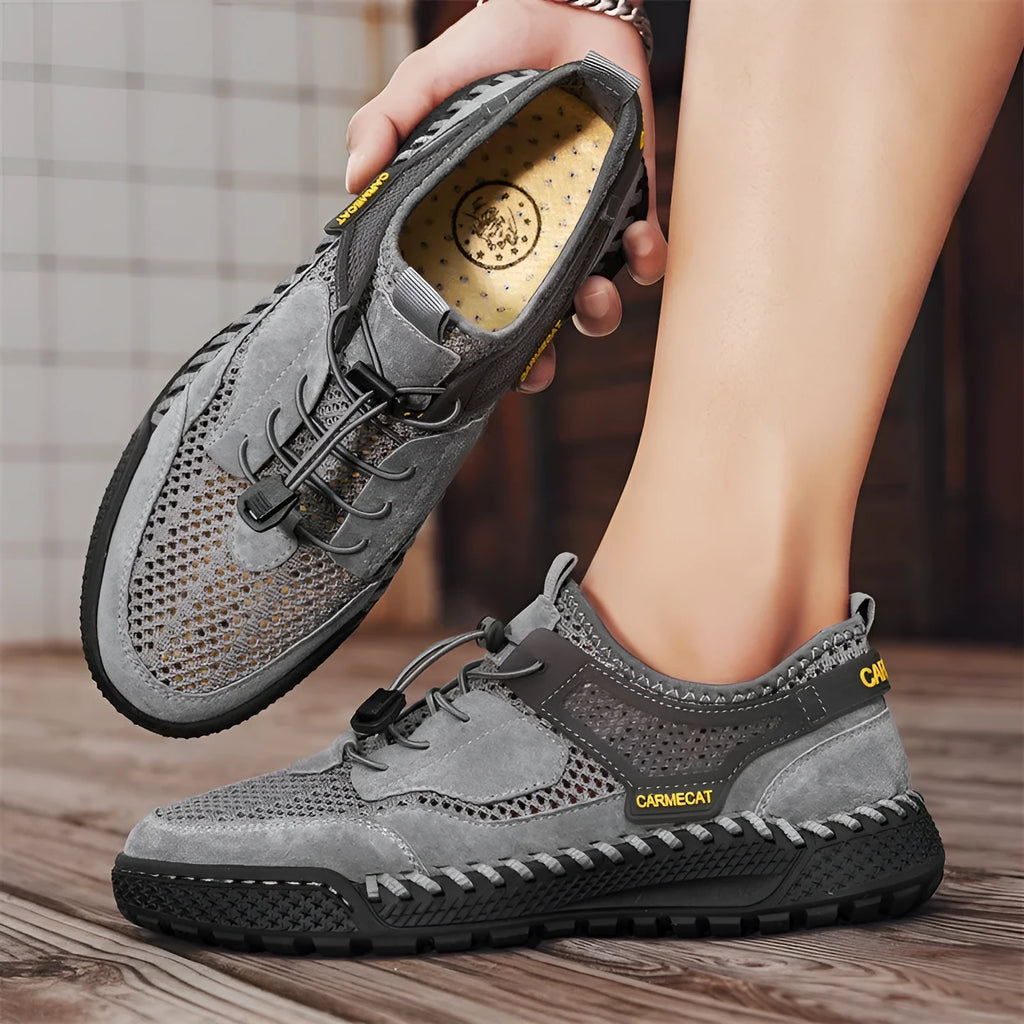 Men's brown suede tennis shoes with elastic band closure and hand-stitched rubber soles