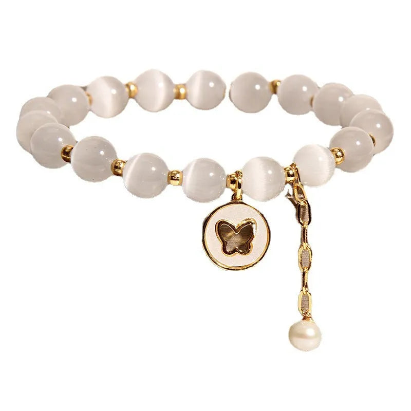 White cat's eye crystal bracelet with geometric design on a wrist