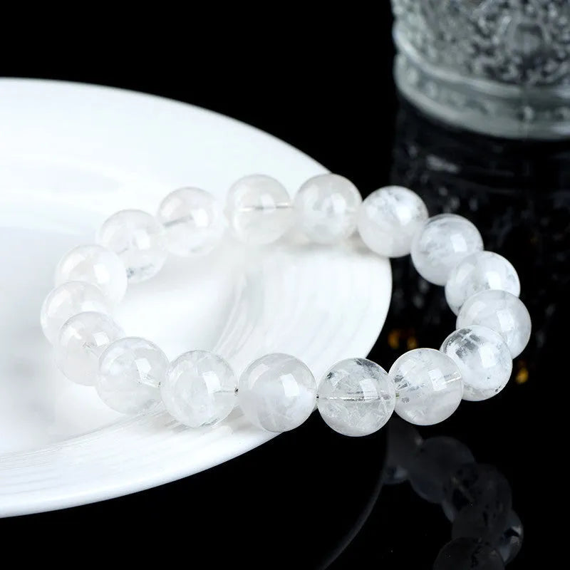 Close-up of a clear crystal blizzard snowflake bead bracelet with Ruyi and Xiangyun design elements.