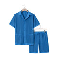 Women's light blue see-through short sleeve cardigan and matching shorts beach set laid flat.