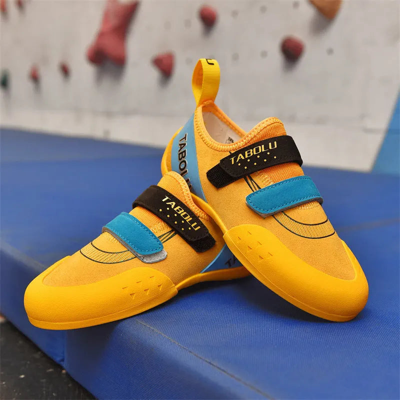 Men's and women's beginner rock climbing shoes with Velcro straps and coloured trim.