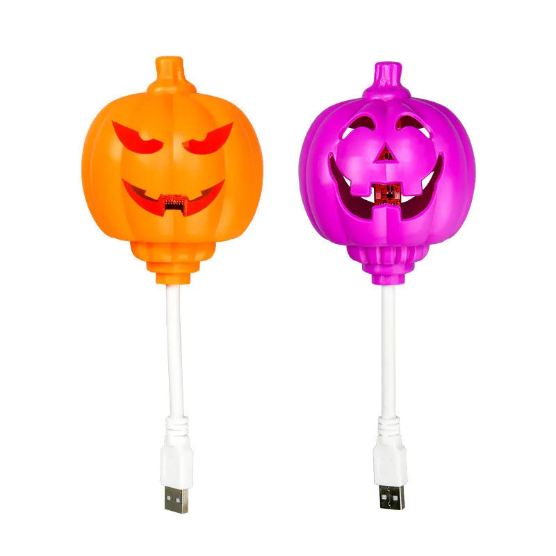 Plastic pumpkin-shaped decorative lamp with USB cable, showing yellow or purple LED light option.