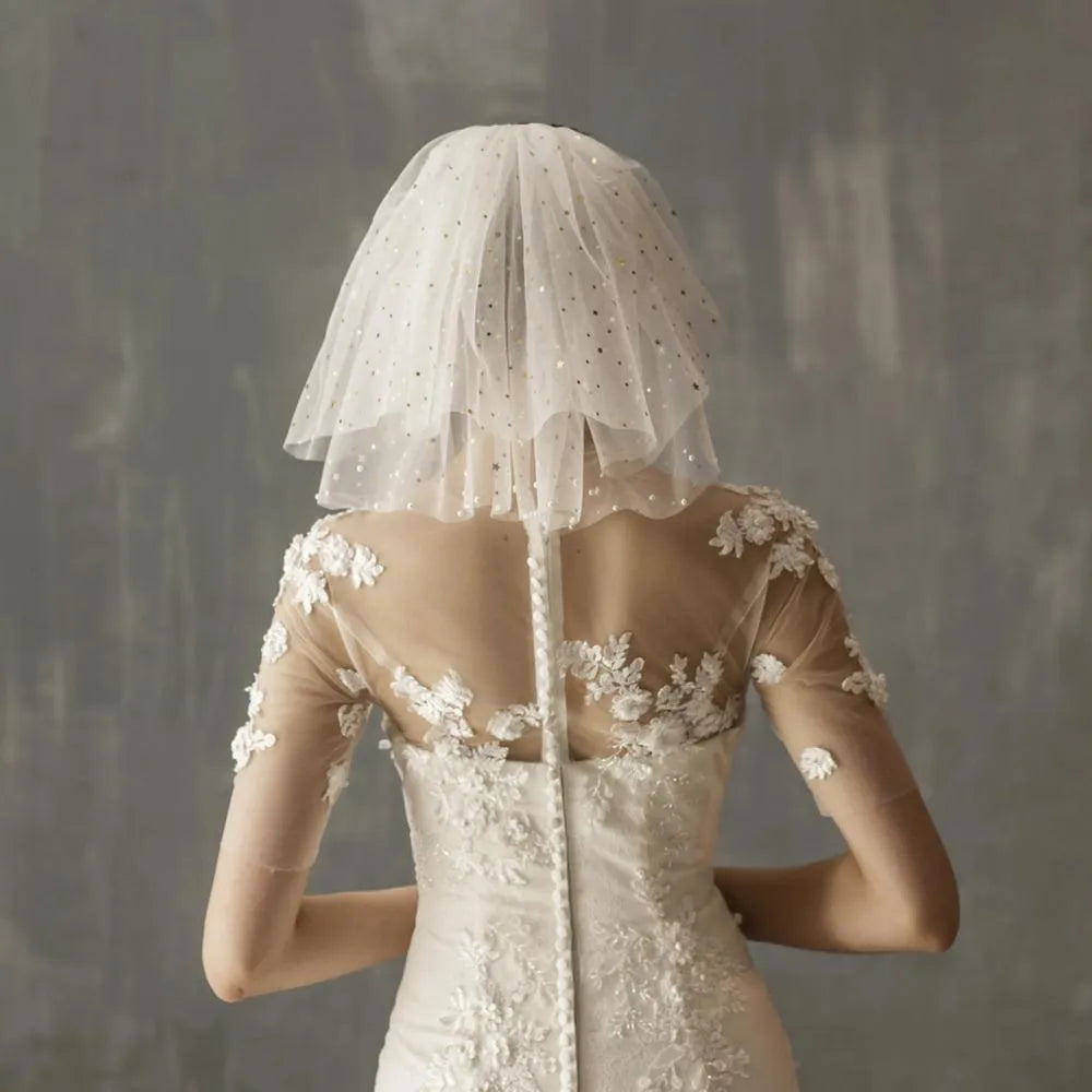 White yarn bridal multi-layer short veil with hair comb on a neutral background