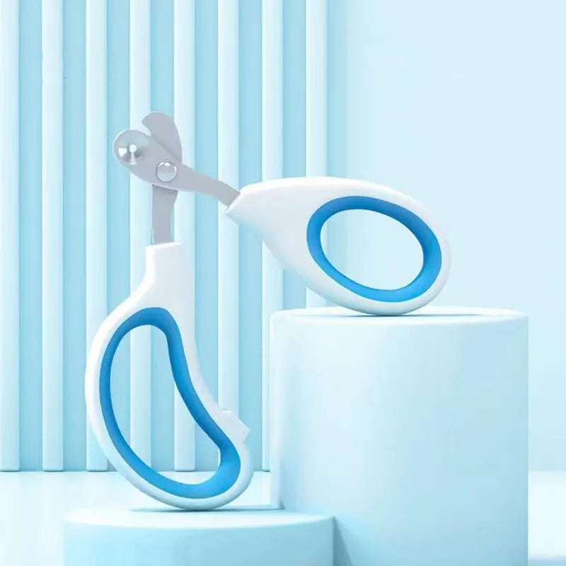 Blue pet nail clippers with circular cut hole and non-slip handles on a white background.