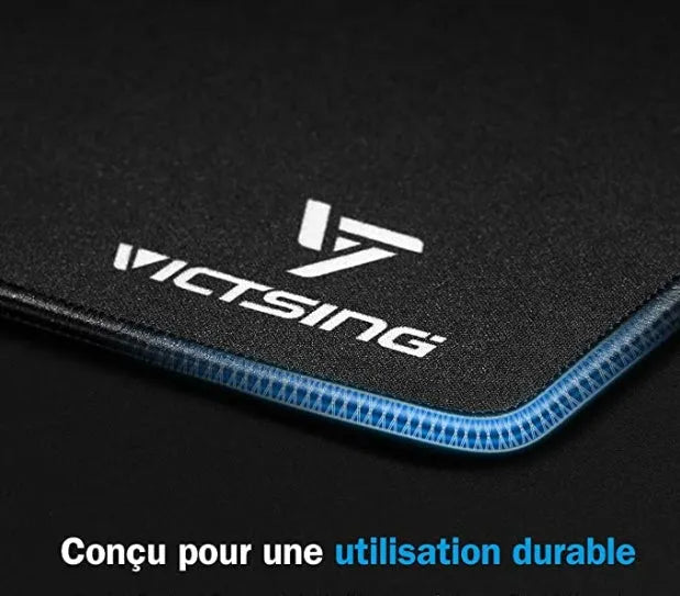 Black thickened rubber mouse pad on a desk, showing its textured surface and substantial 5mm profile.