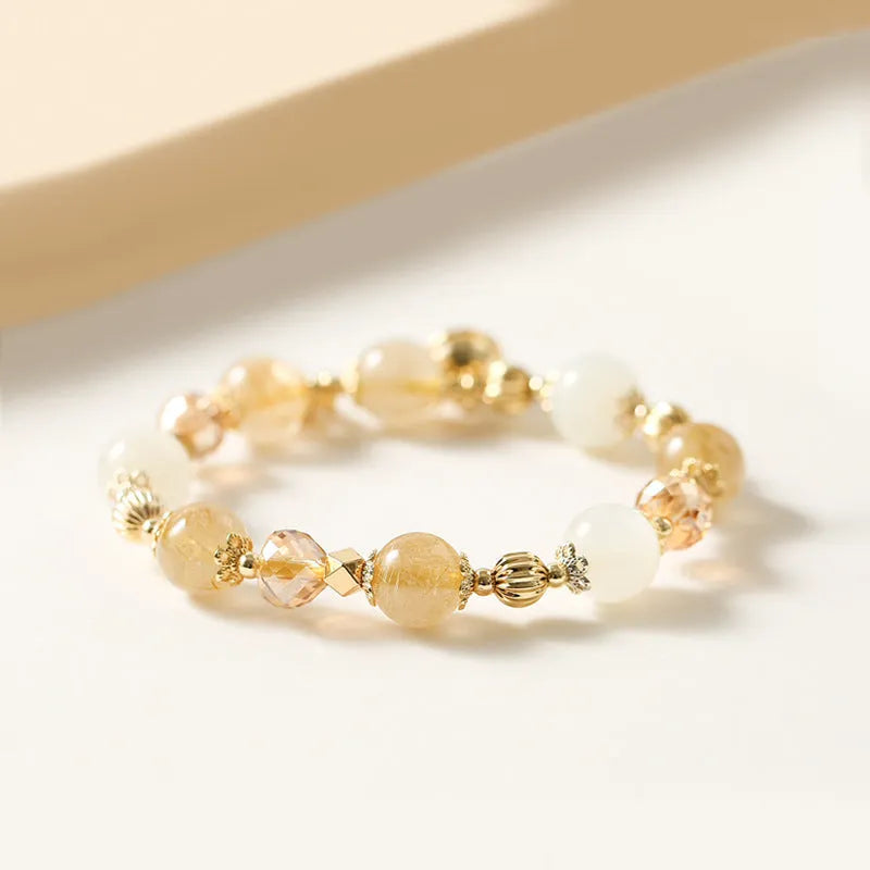 Gold electroplated bracelet featuring natural rutilated quartz crystals with golden rutile needle inclusions