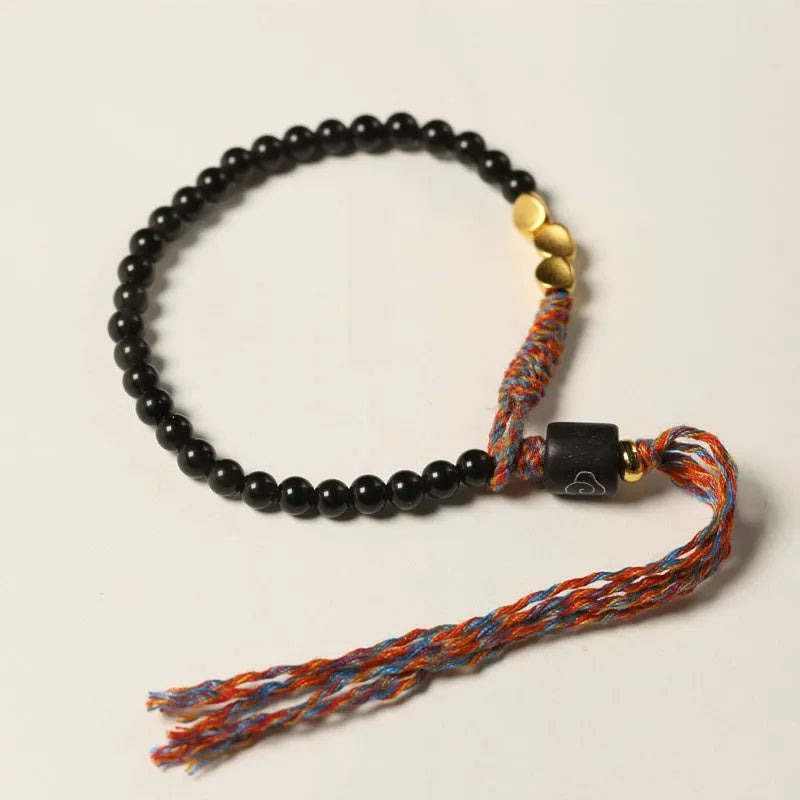 Hand-woven obsidian carrying strap bracelet showing textured surface and adjustable 15.5-16cm length
