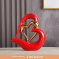 Modern geometric heart ornament in metallic finish displayed on shelf